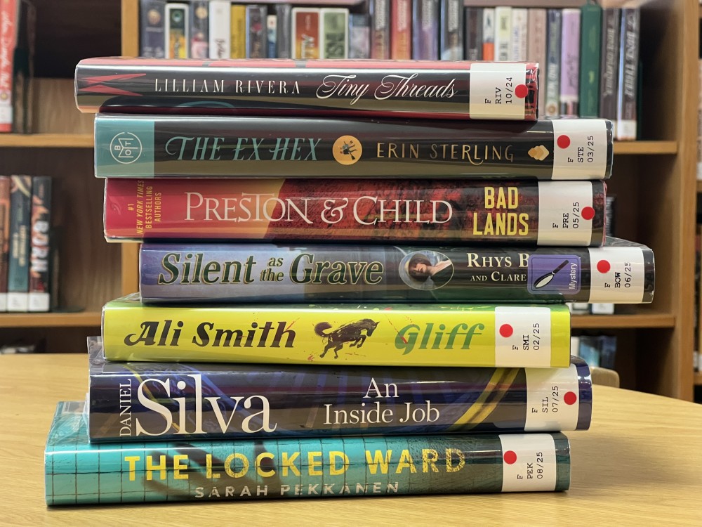 A stack of books sitting on a desk